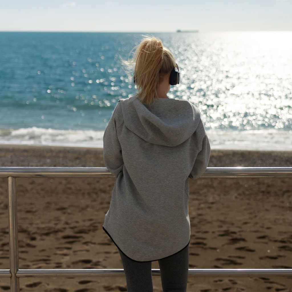 mujer relajada mirando al mar mejorando el descanso y la calma mental
